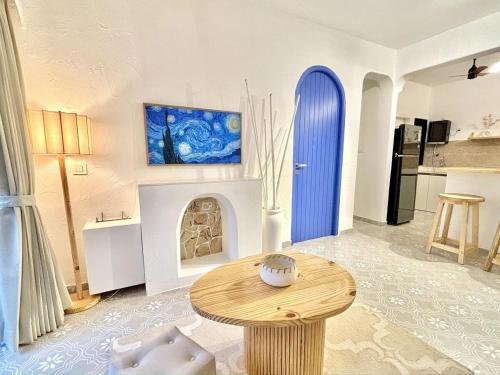 sala de estar con mesa y puerta azul en Chic Mediterranean Retreat in Candolim Sleeps 4, en Calangute