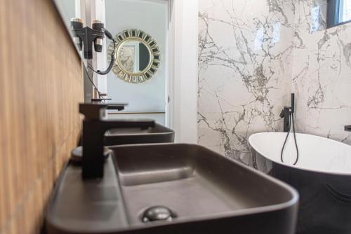 a bathroom with a sink and a toilet and a mirror at AVA Chalet in Comarnic