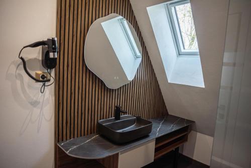 a bathroom with a black sink and a mirror at AVA Chalet in Comarnic