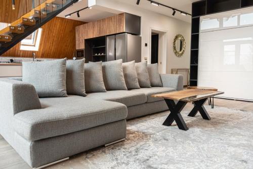 a living room with a couch and a table at AVA Chalet in Comarnic