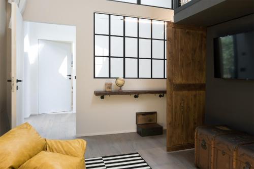 a living room with a couch and a window at Saso' - Casa di charme e relax in Lurate Caccivio