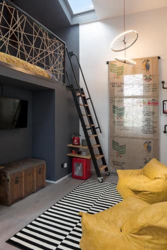 a bedroom with a bunk bed and a ladder at Saso' - Casa di charme e relax in Lurate Caccivio