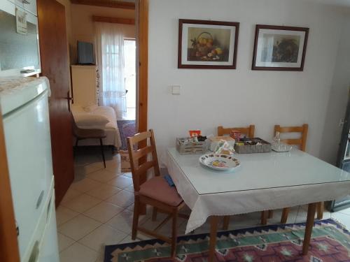 a kitchen and dining room with a table and chairs at Dimitra's traditional house in Katarráktis