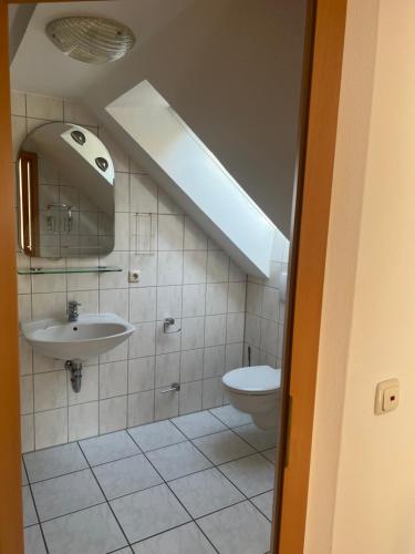 a bathroom with a sink and a toilet at Königszinnenberg Hotel in Bodenwerder