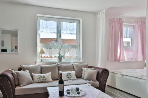 a living room with a couch and a table at Fewo Wellenrauschen in Börgerende-Rethwisch