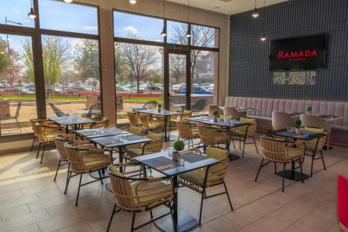 a dining room with tables and chairs in a restaurant at Ramada by Wyndham Madrid Getafe in Getafe