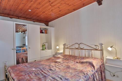 a bedroom with a bed and a wooden ceiling at Waldblick 2 in Kühlungsborn