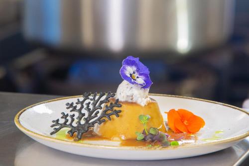 a plate with a dessert with a bird on top of it at Ramada by Wyndham Madrid Getafe in Getafe