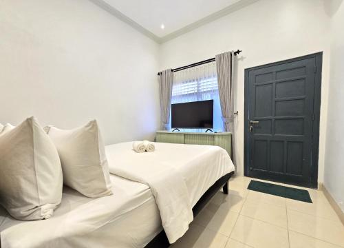 Postel nebo postele na pokoji v ubytování Omah Ceria Guest House