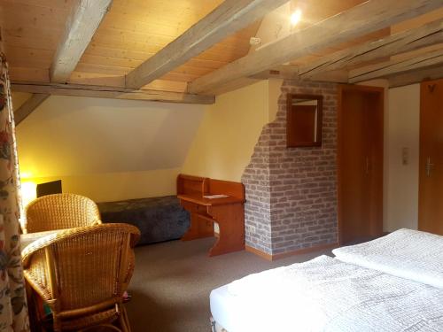 a bedroom with a bed and a brick fireplace at Cafe und Pension am Rennsteig in Blankenstein