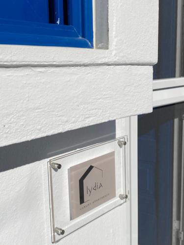 a sign on the side of a building with a window at Vaios Luxury Apartments Polichrono in Polykhrono