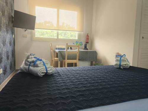 a bedroom with a bed with towels on it at Blue Flowers Room in Scordia