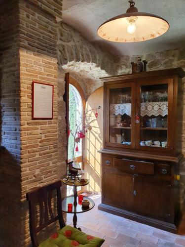 a room with a large wooden cabinet in a brick wall at B&B Casal Cominium in San Donato Val di Comino