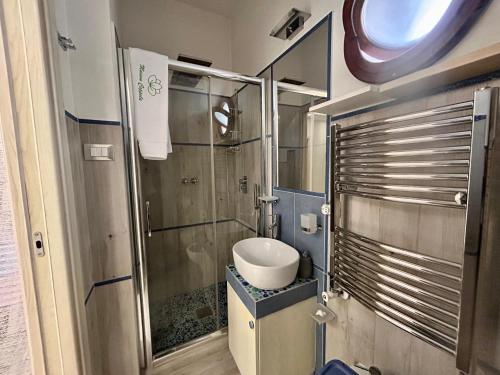 a small bathroom with a sink and a shower at Maison Coppola in Vico Equense