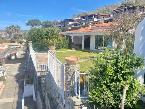 a view of a house with a fence at Villa Taurus Costa dei Monaci Parghelia Tropea in Parghelia