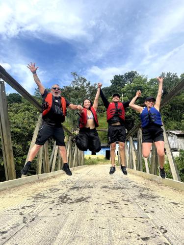 a group of people jumping in the air on a bridge at Aparthotel 2km Parque del Café BOOKUTRIP - 311-227-59-73 in Montenegro