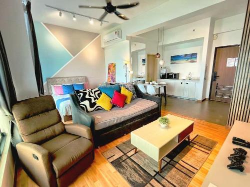 a living room with a couch and a chair at Leisure Imperium Residence Studio Seaview Kuantan in Kuantan