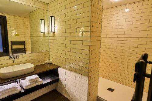 a bathroom with a sink and a mirror at The Vincent Hotel in Southport