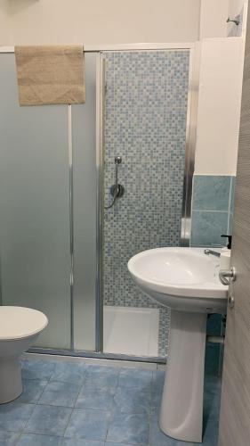 a bathroom with a sink and a glass shower at Home Nala in Giardini Naxos