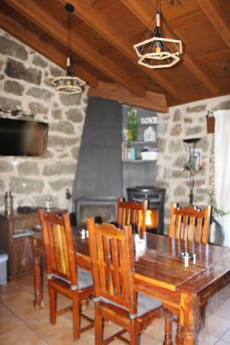 a dining room with a wooden table and chairs at El Balconcillo del Alberche in Navaluenga