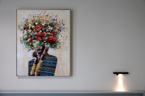 a painting of a woman holding a bouquet of flowers at La Scala Suite in Realmonte