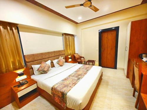 a bedroom with a large bed in a room at Opulence Inn - 500 Meters From Railway Station in Udaipur