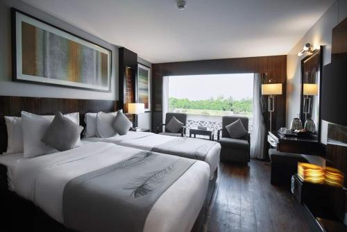 a hotel room with two beds and a living room at Le Fayan Nile Cruise - Till 17-9 Sat From Luxor for 4&7 Nights Wed From Aswan for 3&7 Nights - 18-9 to 20-11 Thu from Luxor for 4&7 Nights Mon From Aswan for 3&7 Nights - 22-12 Mon from Luxor for 4&7 Nights Fri From Aswan in Luxor