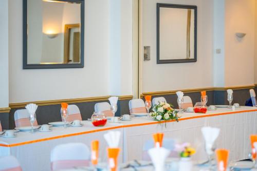 a meeting room with tables and chairs with flowers at The Strathmore Hotel in Morecambe