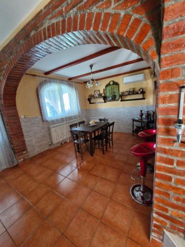 a room with a brick wall and a table and chairs at Vila Soleil in Smederevo