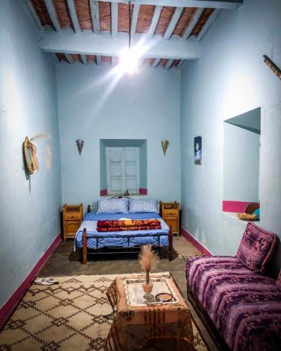 a bedroom with a bed and a couch at Dar Toda - Zagora guest house in Zagora