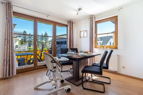 a dining room with a table and chairs and a balcony at Klabautermann in Heringsdorf