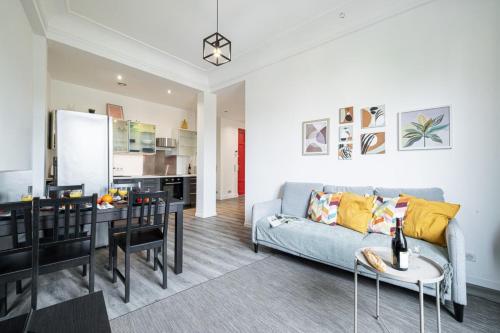 un salon avec un canapé bleu et une table dans l'établissement OLIVETTO - Superb city center apartment with AC, à Nice