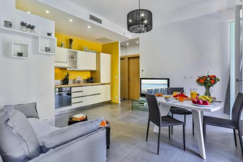 un salon et une cuisine avec un canapé et une table dans l'établissement FRANCE 82 D - 2 rooms - Terrace - 1 min to the Sea, à Nice
