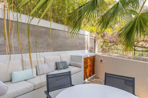 a patio with a couch and a table and chairs at FLH Funchal Terrace Studio in Funchal