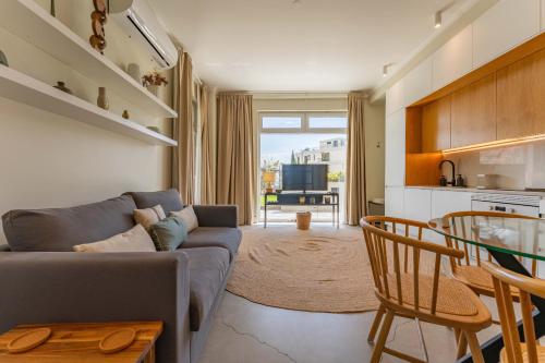 a living room with a couch and a table at FLH Funchal Terrace Studio in Funchal