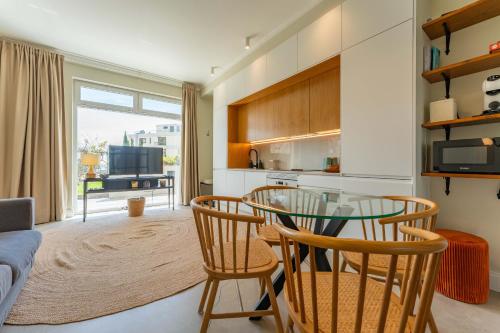 a kitchen and dining room with a glass table and chairs at FLH Funchal Terrace Studio in Funchal
