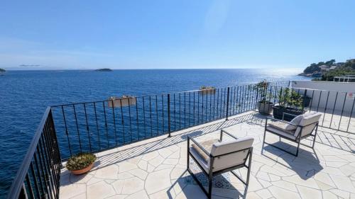 a balcony with chairs and a view of the water at Paradies Apartments Prizba in Blato