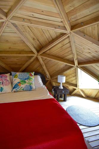 a bed in a room with a wooden ceiling at betsaida in Chiquinquirá