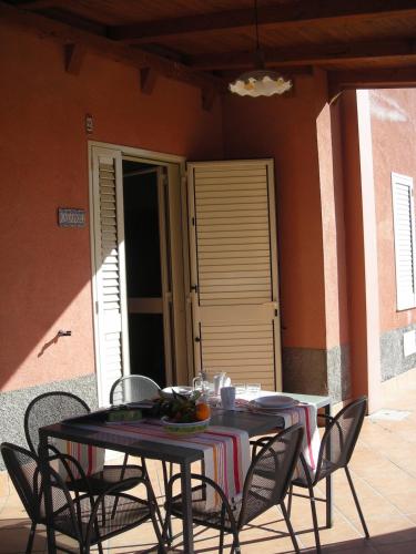 two tables and chairs sitting on a patio at Kalamos Due in Patti