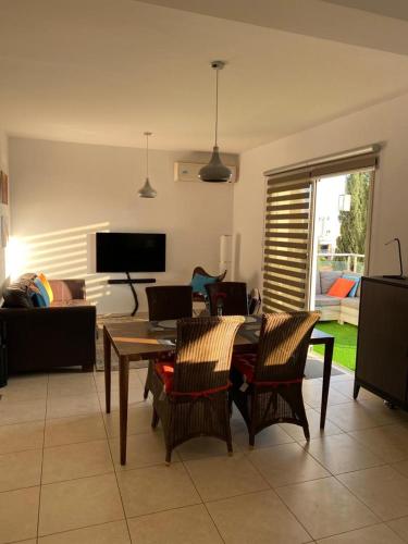 a living room with a table and chairs at Gorgeous 1 Bedroom apartment close to Town Centre in Limassol