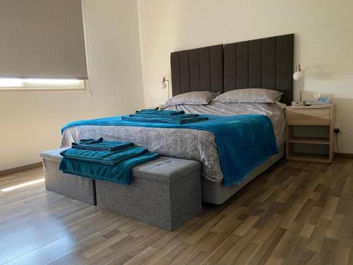 a bedroom with a large bed and a wooden floor at Gorgeous 1 Bedroom apartment close to Town Centre in Limassol