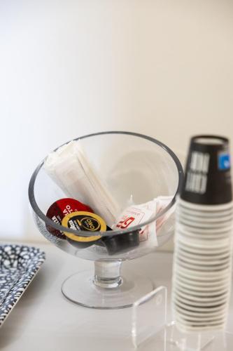 a glass bowl with drinks and a bottle of water at La Scala Suite in Realmonte