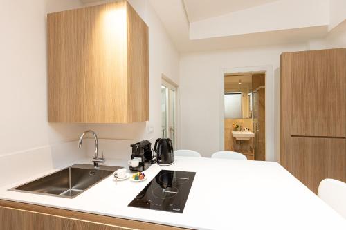 a kitchen with a sink and a counter at Amazing Via del Corso 277 Suites in Rome