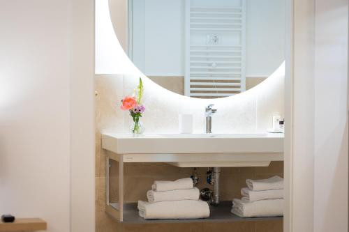 a bathroom with a sink and a mirror at Amazing Via del Corso 277 Suites in Rome