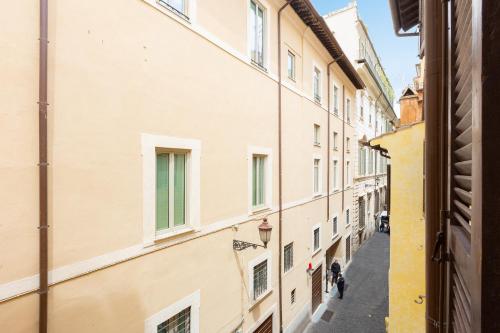 an alleyway between two buildings in a city at Amazing Via del Corso 277 Suites in Rome