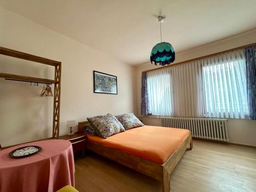 a bedroom with a bed and a table and a mirror at Goldner Stern Kaub in Kaub
