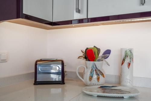 a kitchen counter with a vase and a toaster at Tranquil house in Kipséli