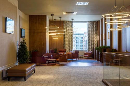 a lobby with couches and chairs and a waiting room at Radisson Hotel & Apartments Gdansk in Gdańsk