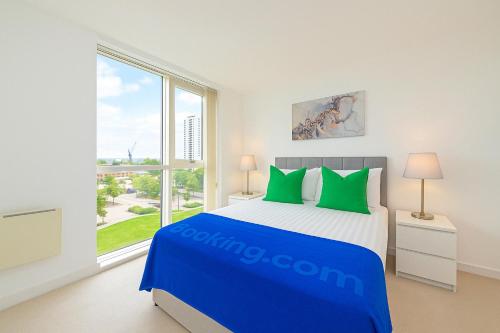 a bedroom with a bed and a large window at Grand Apartments Kew Gardens in London