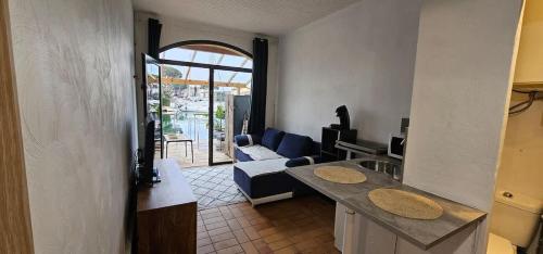 a living room with a couch and a table in a room at Marina Apartment Port Grimaud in Grimaud